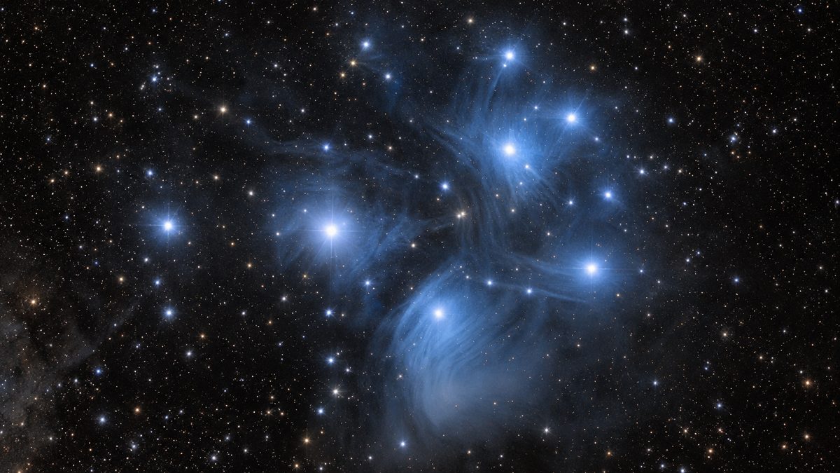 Illustration of the bright stars of the Pleiades wrapped in faint blue reflection nebulosity
